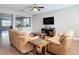 Cozy living room with tile floors, ceiling fan, and a decorative cut out to the dining room at 3709 Cedar Hammock Trl, St Cloud, FL 34772