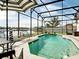 Overhead view of a screened in pool and patio with a lake view at 3709 Cedar Hammock Trl, St Cloud, FL 34772