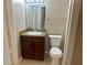 Traditional bathroom with a brown vanity, sink and standard white toilet at 401 Fountainhead Cir # 155, Kissimmee, FL 34741