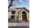 Two-story condo building featuring colorful facades, a red tile roof, and arched entryway at 401 Fountainhead Cir # 155, Kissimmee, FL 34741