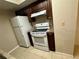 Kitchen with stainless steel sink, granite countertops and white appliances at 401 Fountainhead Cir # 155, Kissimmee, FL 34741