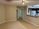 Living room features neutral paint, ceiling fan, tile flooring and pass through to kitchen at 401 Fountainhead Cir # 155, Kissimmee, FL 34741