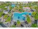 Aerial view of a stunning community pool area with a water slide, surrounded by tropical landscaping at 7059 Nemours Pkwy, Orlando, FL 32827
