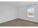 Cozy bedroom with neutral carpeting and a window that provides natural light at 7059 Nemours Pkwy, Orlando, FL 32827
