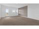 Bedroom with large windows, balcony access, and decorative accent wall at 7059 Nemours Pkwy, Orlando, FL 32827
