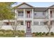 Charming two-story home with a welcoming red door and nicely landscaped front yard at 7059 Nemours Pkwy, Orlando, FL 32827