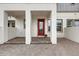 Inviting front porch features brick paving and a striking red door at 7059 Nemours Pkwy, Orlando, FL 32827