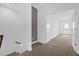 Hallway leading to the bedrooms with carpet at 7059 Nemours Pkwy, Orlando, FL 32827