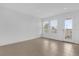 Bright living room with neutral tile flooring, recessed lighting, and a glass door to the outside at 7059 Nemours Pkwy, Orlando, FL 32827