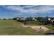 Scenic aerial view of the condos overlooking the lush green golf course and community at 7673 Heritage Crossing Way # 301, Reunion, FL 34747