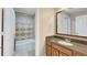 Well-maintained bathroom with a shower-tub combo with decorative tile and a granite vanity at 7673 Heritage Crossing Way # 301, Reunion, FL 34747