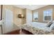 Comfortable bedroom with mounted TV, ample natural light from windows, and a decorative dresser at 7673 Heritage Crossing Way # 301, Reunion, FL 34747