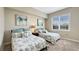Bedroom features two beds, neutral tones, and a window with natural light at 7673 Heritage Crossing Way # 301, Reunion, FL 34747