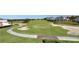 Scenic aerial view of the meticulously landscaped golf course and surrounding properties at 7673 Heritage Crossing Way # 301, Reunion, FL 34747