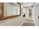 Hallway with mirrors reflecting bedroom and bathroom, providing a sense of space at 7673 Heritage Crossing Way # 301, Reunion, FL 34747