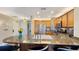 Open-concept kitchen with granite countertops, stainless steel appliances, and an island with bar seating at 7673 Heritage Crossing Way # 301, Reunion, FL 34747