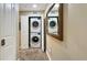 Convenient laundry room with stacked washer and dryer for efficient use of space at 7673 Heritage Crossing Way # 301, Reunion, FL 34747