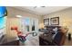 Well-decorated living area with a modern interior, plush seating, and access to the balcony through French doors at 7673 Heritage Crossing Way # 301, Reunion, FL 34747