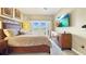 Comfortable main bedroom featuring a large bed, neutral colors, and a decorative dresser at 7673 Heritage Crossing Way # 301, Reunion, FL 34747