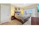 Spacious main bedroom with a king-size bed, French doors, and elegant décor at 7673 Heritage Crossing Way # 301, Reunion, FL 34747