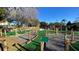 A beautifully designed mini golf course with multiple holes, lush landscaping, and scenic views of the community at 7673 Heritage Crossing Way # 301, Reunion, FL 34747
