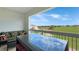 Outdoor patio with glass table and seating area overlooking the beautiful golf course at 7673 Heritage Crossing Way # 301, Reunion, FL 34747