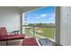 Covered patio area with comfortable seating and scenic views of the golf course at 7673 Heritage Crossing Way # 301, Reunion, FL 34747