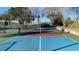 Outdoor pickleball court, set against lush greenery and offering a great space for recreation and exercise at 7673 Heritage Crossing Way # 301, Reunion, FL 34747