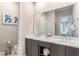 Modern bathroom featuring double sinks, gray cabinetry, and a large mirror reflecting the bright, clean space at 7760 Sandy Ridge Dr # 108, Reunion, FL 34747