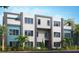 Contemporary townhome featuring a mix of white and blue siding, accented by modern dark gray trim at 7760 Sandy Ridge Dr # 108, Reunion, FL 34747