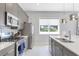 Stylish kitchen featuring gray cabinetry, stainless steel appliances, and a bright white countertop at 7760 Sandy Ridge Dr # 108, Reunion, FL 34747