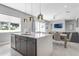 Open-concept kitchen featuring a quartz island, stainless steel appliances, and seamless connection to the living area at 7760 Sandy Ridge Dr # 108, Reunion, FL 34747