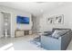 Cozy living room with a flat screen tv and adjacent half bath showcasing a modern and sleek design at 7760 Sandy Ridge Dr # 108, Reunion, FL 34747