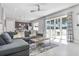Bright living room featuring a plush sofa, stylish rug, and glass doors leading to an outdoor space at 7760 Sandy Ridge Dr # 108, Reunion, FL 34747