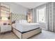 Elegant primary bedroom showcasing a tufted headboard, soft lighting, and stylish decor at 7760 Sandy Ridge Dr # 108, Reunion, FL 34747