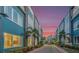 Townhomes lining a street with palm trees, showcasing modern architecture and vibrant community atmosphere at 7760 Sandy Ridge Dr # 108, Reunion, FL 34747