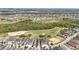 Real estate with a golf course in background, surrounded by trees and houses at 785 Desert Mountain Ct, Reunion, FL 34747