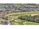Breathtaking aerial shot of a golf course community with lake and high-end homes at 785 Desert Mountain Ct, Reunion, FL 34747