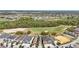 Aerial view of tan houses alongside golf course with trees in background at 785 Desert Mountain Ct, Reunion, FL 34747