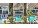 Aerial view of backyard pool and patio, featuring a dining table and lounge chairs at 785 Desert Mountain Ct, Reunion, FL 34747