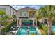 Outdoor backyard pool with a patio, lounge chairs, and a dining table at 785 Desert Mountain Ct, Reunion, FL 34747