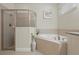 Bright bathroom featuring a soaking tub and glass-enclosed shower at 785 Desert Mountain Ct, Reunion, FL 34747