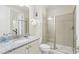 Bright bathroom featuring granite countertop vanity and glass enclosed shower stall at 785 Desert Mountain Ct, Reunion, FL 34747