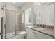 Bright bathroom with a glass door shower, granite countertop and neutral colors at 785 Desert Mountain Ct, Reunion, FL 34747