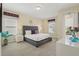 Comfortable bedroom featuring neutral colors, plush carpet, and balcony access at 785 Desert Mountain Ct, Reunion, FL 34747