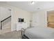 Cozy bedroom featuring a large bed, a TV, and open access to the stairway and bathroom at 785 Desert Mountain Ct, Reunion, FL 34747