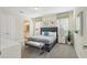 Serene primary bedroom with a plush bed, a bench, and a view into the primary bath at 785 Desert Mountain Ct, Reunion, FL 34747