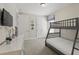 Carpeted bedroom with bunk beds, wall mounted television and double door closet at 785 Desert Mountain Ct, Reunion, FL 34747