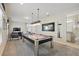 Bright game room includes a pool table, seating area, and adjacent bathroom for convenience at 785 Desert Mountain Ct, Reunion, FL 34747