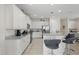 Modern kitchen featuring white cabinets, granite countertops, stainless steel appliances, and bar seating at 785 Desert Mountain Ct, Reunion, FL 34747